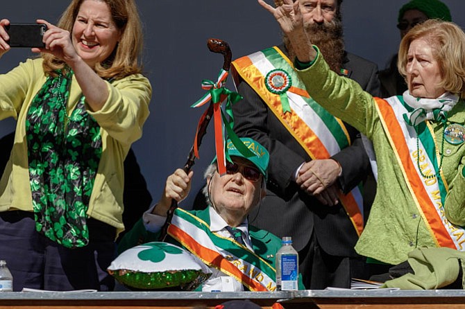 Mayor Allison Silberberg, left, joins parade Grand Marshals Pat and Bernadette Troy on the reviewing stand.