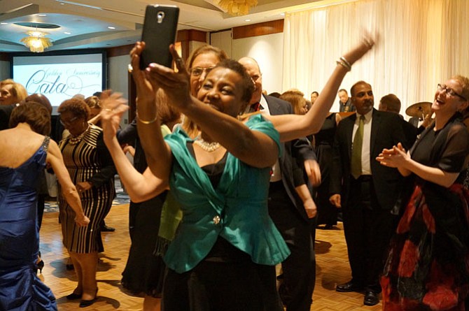 Amanda Chandler poses for a selfie with a friend as they dance to the music of Bruthers Plus One.