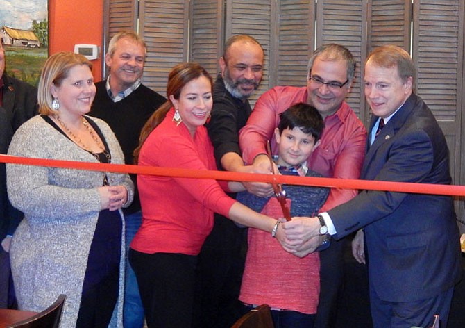 Cutting the restaurant’s ribbon are (from left) Fairfax City Councilwoman Jennifer Passey, the Economic Development Authority’s Craig Havenner, Angela Ribulotta, Chef Elvis Amor, Dante Ribulotta, Angela’s son Lorenzo, 9, and Mayor David Meyer.