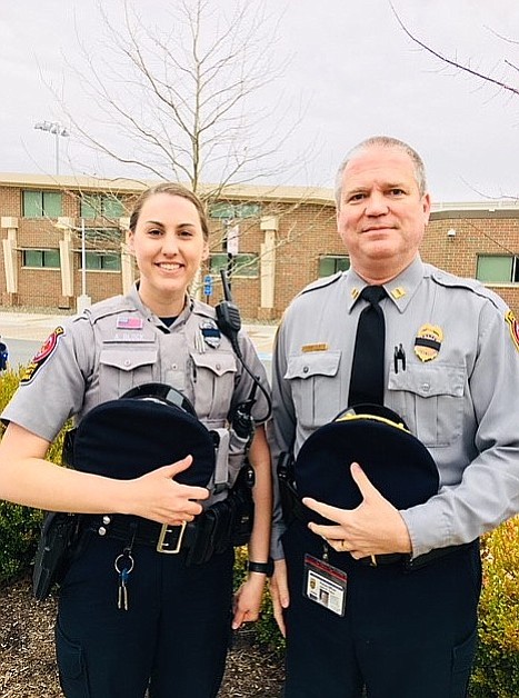 Officer Ashley Block with Capt. John Trace. Block, a McLean District Station police officer, was severely injured while helping clear a road during the March 2 wind storm.