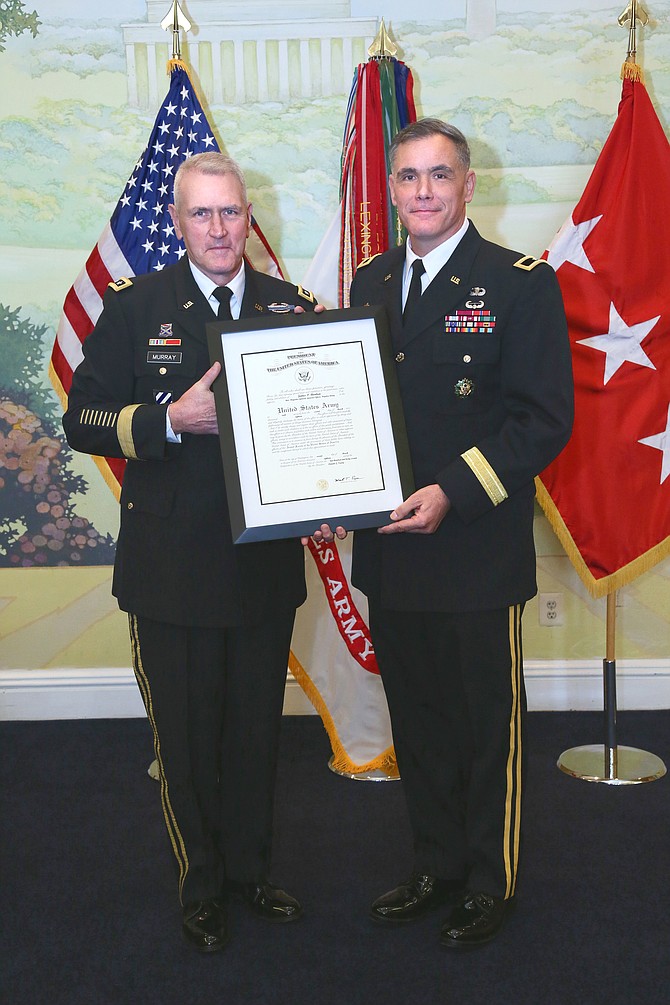 New U.S. Army Brigadier General James P. Bienlien (right) receives his promotion order from U.S. Army Lieutenant General Mike Murray on March 23 at Patton Hall in Ft. Meyer, Va.