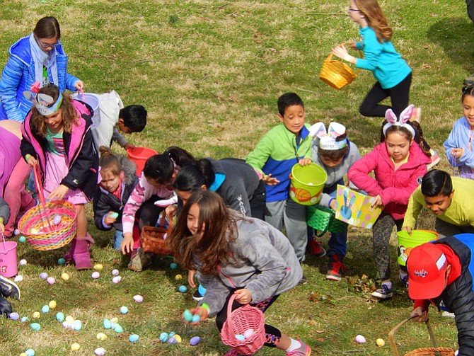 Children excitedly collect their Easter eggs.