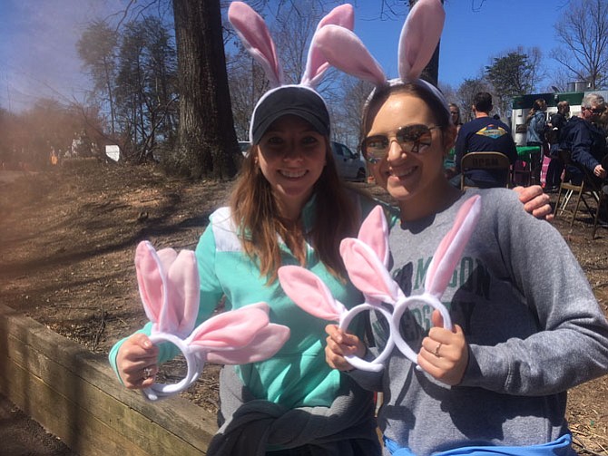 Brooklyn Rains and Maggie Deboard, therapeutic recreation majors from George Mason University, hand out bunny ears to all that want to wear them.