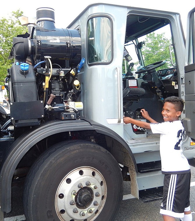 Operating the sidearm loader of this Fairfax County trash truck at a 2016 Touch-A-Truck event in Chantilly is Arnold Reyes, then 10. Touch-A-Truck will be part of Springfest.