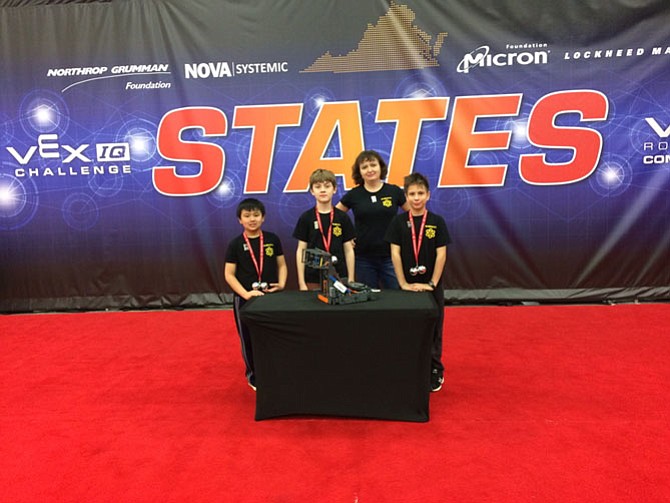 Three students at Aldrin Elementary School in Reston, David Nelson, Connor Uehara and Anthony Starkov, won this year's Vex IQ Robotics Virginia State Championship, elementary school division. They are pictured with the Team Coach, Zina Raye.