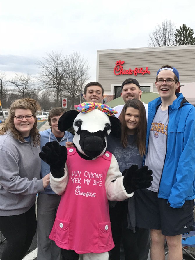 The Chick-fil-A Baby Cow joins (from left) Stephanie Anderson, Carson Walmsley, Alex Ladd, Matt Anderson, Stacey Anderson and John Anderson at the start of the 24 hour ' 'Chick-fil-A First 100.'  Group members reside in Reston or Great Falls. 