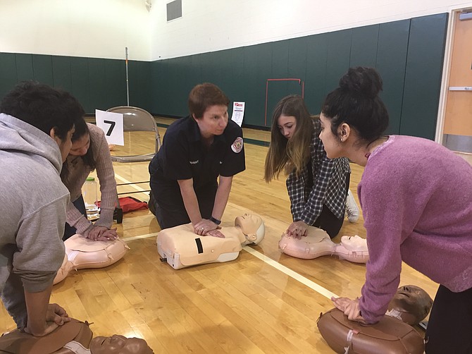 Hillary Lindsay from the Alexandria Fire Department teaching CPR.