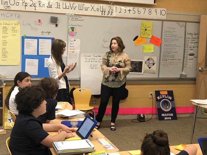 Potomac Almanac writer Colleen Healy is interviewed April 13 by teacher Carolyn Cohen and the reporters of the Little Bulldog, the lower school newspaper at the Bullis School. 