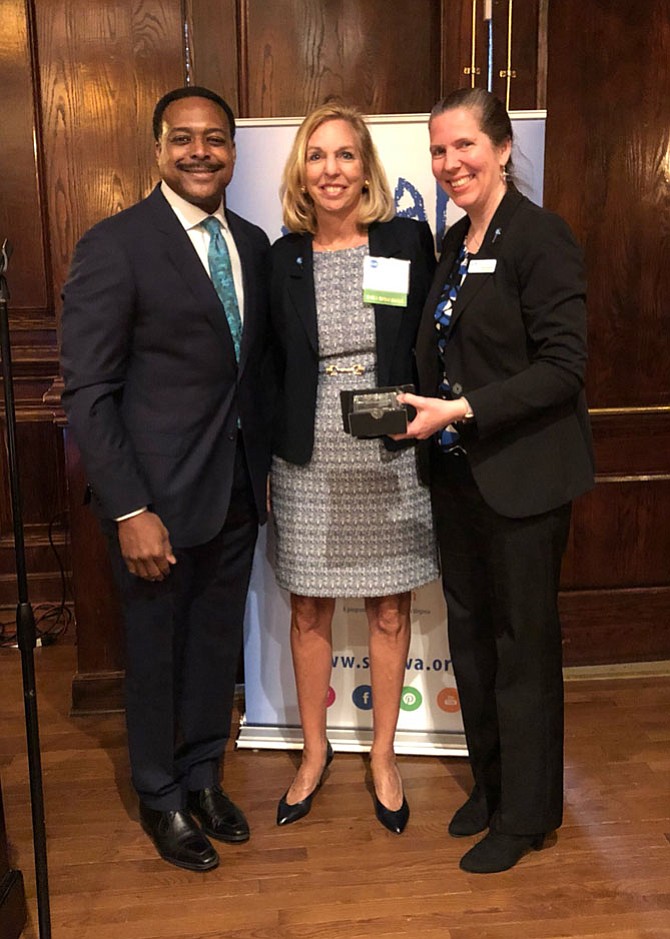 NBC4's Leon Harris (SCAN Honorary Board Member and emcee of the event); 2018 Ally in Prevention Award Winner Bootsie Humenansky from Fairfax; and Sonia Quiñónez, SCAN Executive Director.