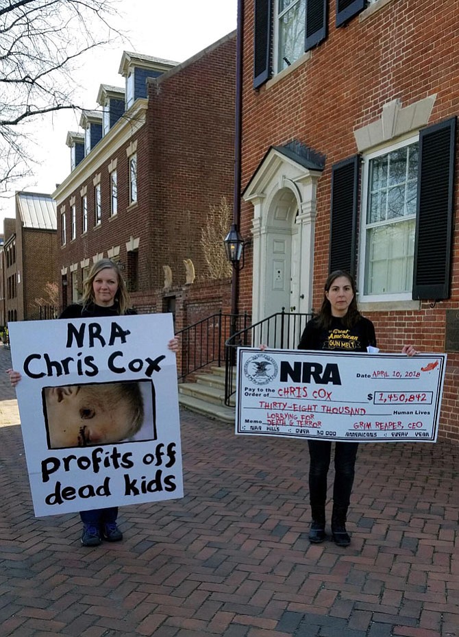Gun control advocates Amanda Gailey of Lincoln, Nebraska, and Catherine Koebel Stromberg of Roanoke protest in Old Town.