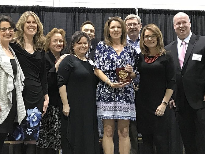 Mayor Lisa C. Merkel (second from right) presents Karen Joseph (center) the Distinguished Service Award for her work in creating and maintaining the Food for Neighbors Program as (from left) Del. Jennifer Boysko, (D-86); Town Councilmembers Jennifer Baker, Sheila Olem and Signe Friedrichs; Tommy McFly, Dranesville Supervisor John Foust, (D), and Town Councilmember Bill McKenna join.