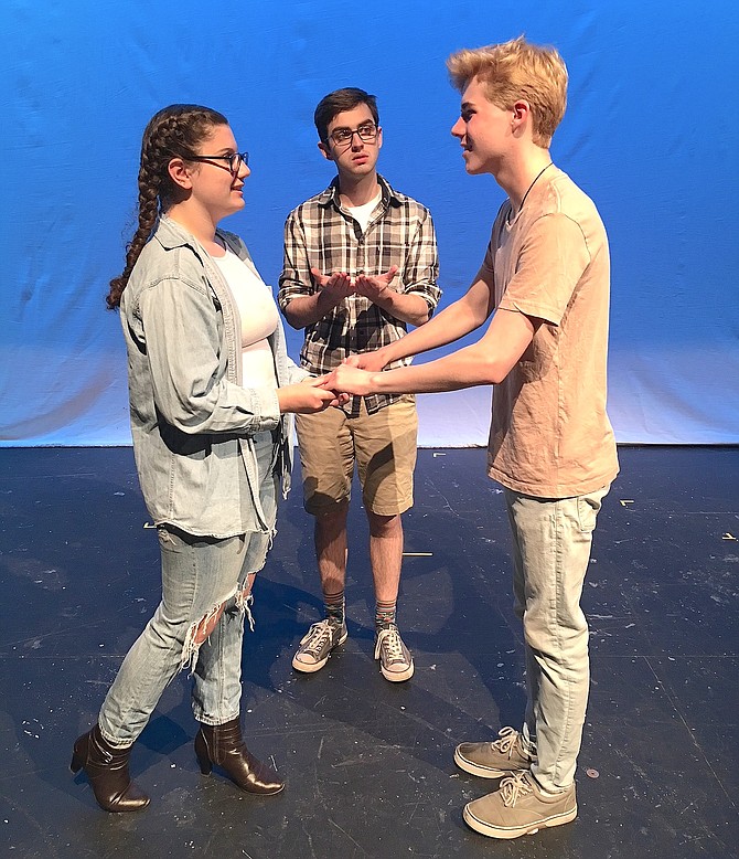 In Woodson High’s “Our Town,” Michael Richardson (center) plays the minister marrying sweethearts Emily (Grace Bonaccorsy) and George (Andrew Black).