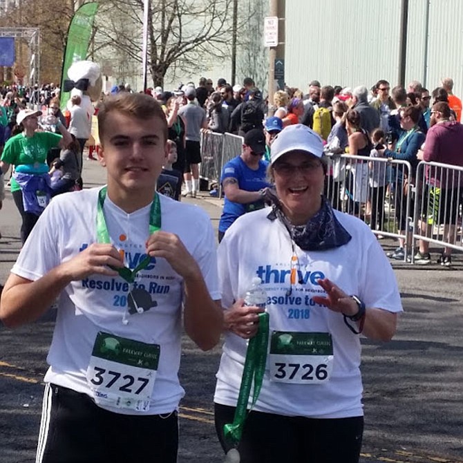 Arlington Thrive was the beneficiary of these runners’ “resolve to run” which takes place starting in January and ends at the race. Here mother and son, Barbara and James Brady, show their medals with pride. 