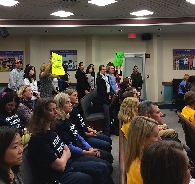 Parents held up signs to express solidarity with speakers.