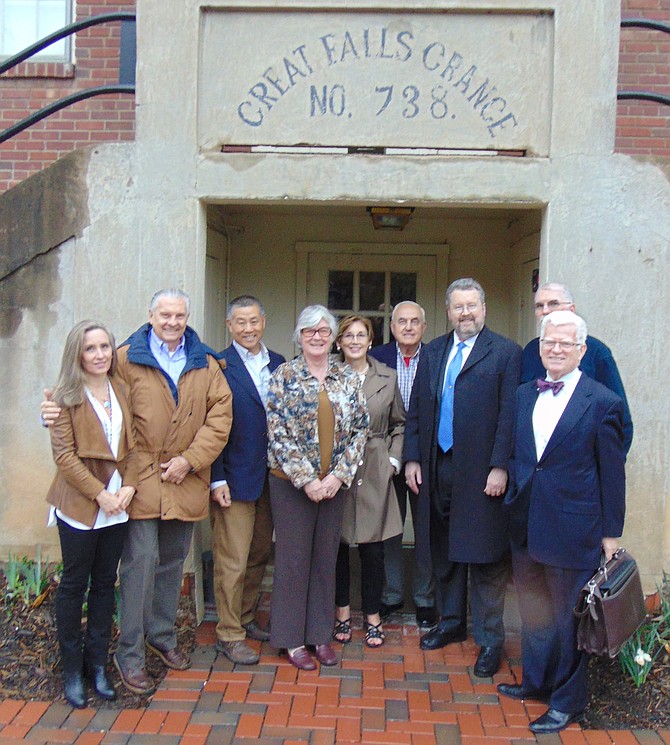 Standing in front of the Great Falls Grange are community leaders (from left): Suzanne Pidgeon, Jorge Adeler, Gary Pan, Linda Jones, Linda Thompson, Glen Sjoblom, G. Stephen Dulaney, Eric Knudsen, and John McGeehan.