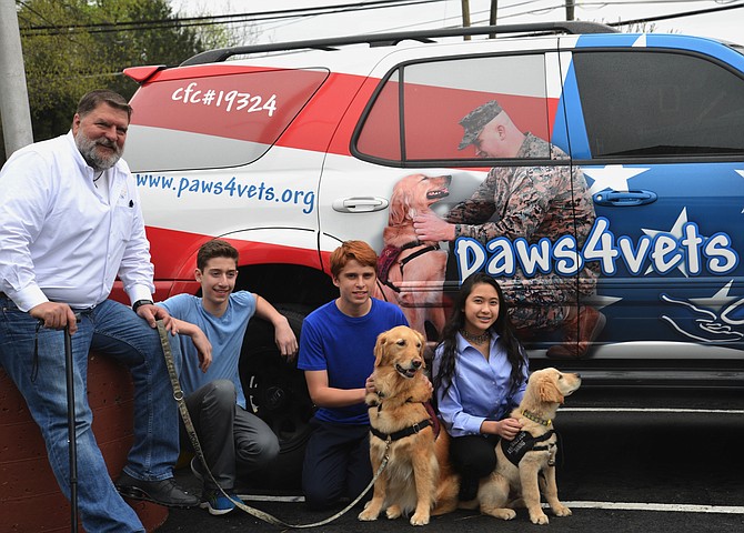 From left, paws4vets client, and now a Relationship Development Officer for the paws4people foundation, Randy Powers attended the DEL Donates-organized fundraiser with his canine partner MORGAN. DEL Donates founder Dylan Kurtz of Great Falls, and Kilmer Middle School classmates and fellow philanthropists Evan Preta [with MORGAN] and Lara Jae Evangelista [with SILAS].