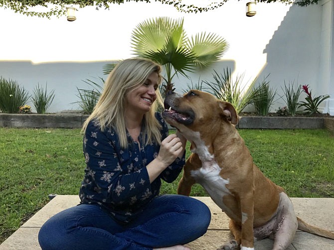 Samantha Elfmont, formerly of Alexandria, in the backyard of her new home in Monterrey, Mexico, with her pal Max.