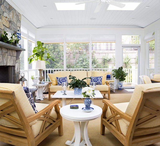 Kelley Proxmire suggests using plants and planters in a variety of sizes — such as these blue and white ceramic pots, to create a light and airy patio space.