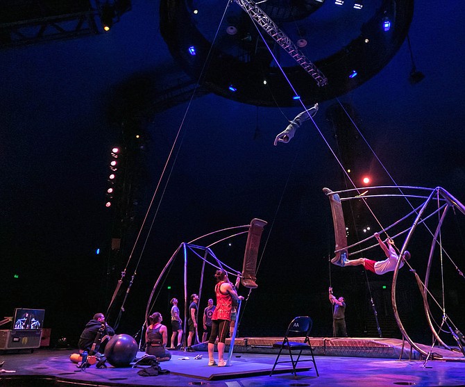 Acrobats practicing the Russian swings. Practice is filmed and then shown on a tv next to them with a delay so they can see exactly how they did and what mistakes they may or may not have made.