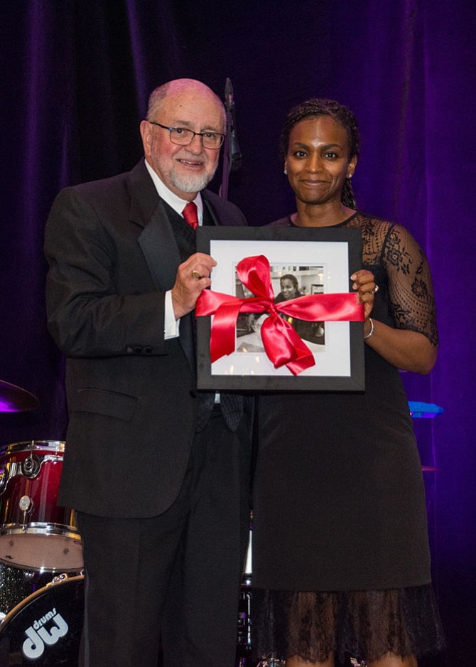 Micheline Diakite, right, is honored as a “Portraits of Success” recipient by John Porter at the April 28 SFA Gala.