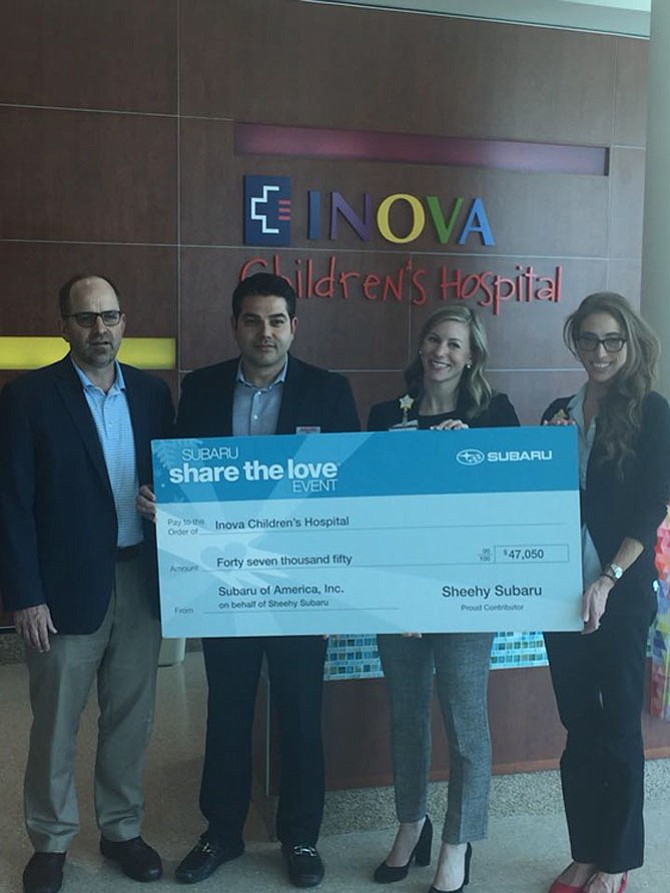 From left, Paul Sheehy, Used Vehicle Director at Sheehy Auto Stores, and Russ Zakeri, General Manager of Sheehy Subaru, with Joanna Fazio and Jamie Gentile of Inova Children’s Hospital.