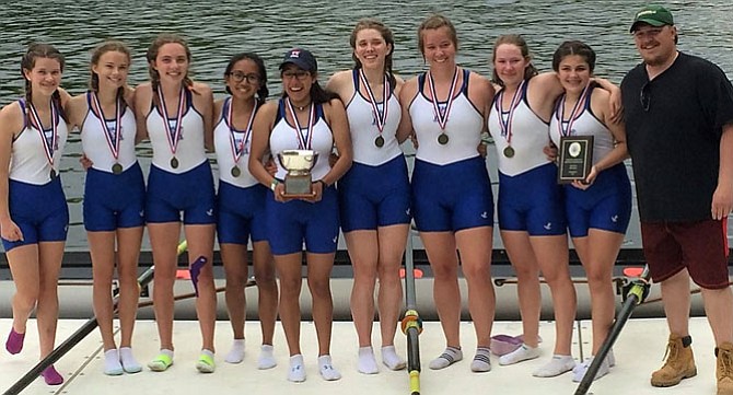 The State Champion TC Women's Third 8 with Coach Chris Ottie.