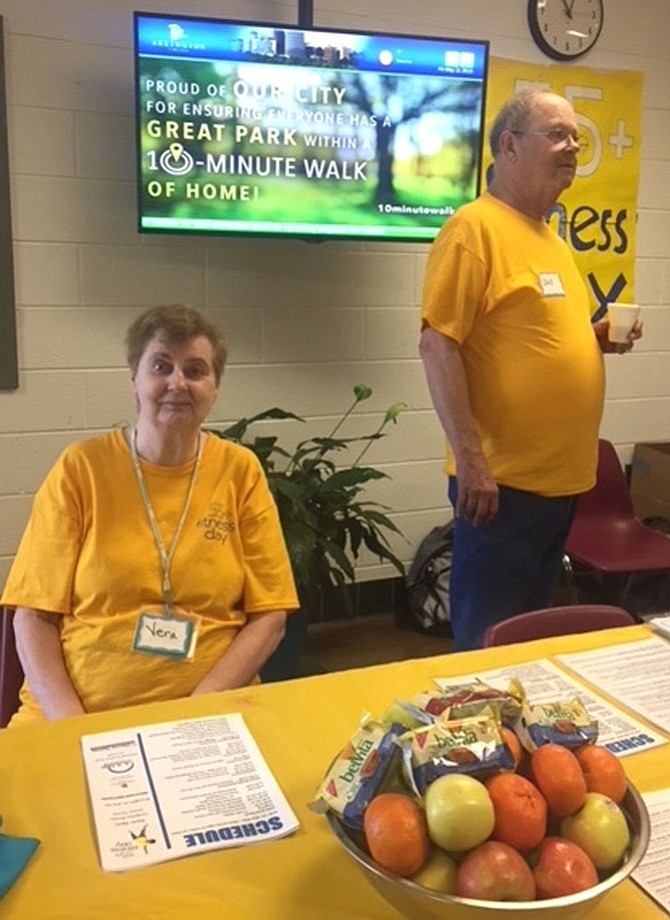 Robert King and Vera Liberu direct visitors to the senior activities offered at 55+ fitness day at Langston-Brown Senior Center on May 11.