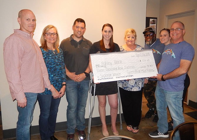 MOD Pizza presents a ceremonial check to Officer Ashley Block. From left are her dad, Kerry Block; stepmom, Tammy Block; boyfriend, PFC Sharif Issa of the McLean District Station; Block; her mom, Janet Winner; Greenbriar MOD General Manager Dean Ladson; store trainee Jenny Bye; and MOD District Manager Dirk Huber.
