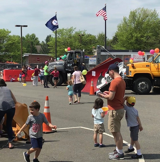 Parents, grandparents and children enjoy a day with the monster machines of the Town of Herndon Department of Public Works at Big Truck Days 2018. Attendees at the event donated approximately 150-200 bags of food to LINK to benefit those in need in the area.