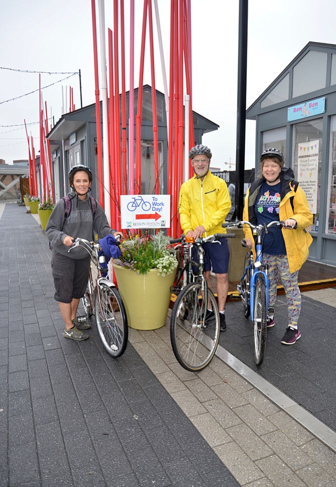 From left: Terri Haskell from Herndon, and Tom Crotty and Kim Sigle from Reston, joined up at the Reston-Wiehle Bike to Work pit stop to check out the action, before pedalling off to Lake Anne Elementary in Reston, where all three work. 