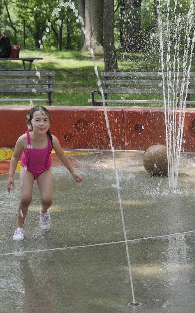 Grace Luk hits the spraypark at Hayes Park as it opens for summer.
