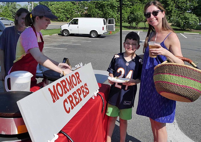 Cooper Hallett chooses a chocolate crepe for his breakfast at the Marymount Farmers Market on Saturday, May 26. Mormor Crepes is a new stand at the market this year, joining 17 others offering a variety of different tastes.