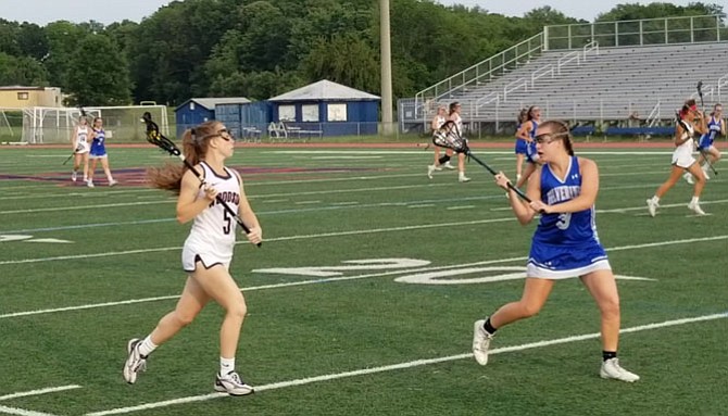 West Potomac junior Lauren McDonald, right, defends Woodson senior Logan Dougherty during Tuesday’s Region 6C championship game.