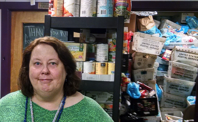 Rising Hope Food Pantry Coordinator Kathleen Simons with Stamp Out Hunger bins.