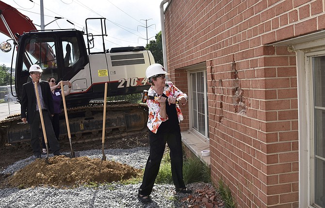 Former state Sen. Mary Margaret Whipple takes a whack at the wall of the Berkeley during the Knock Down event May 31.