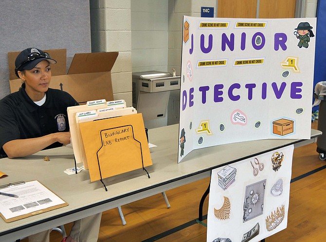 Officer Lillian Hammond on the Arlington County Outreach Team is in charge of the Junior Detective Table. She says this is the second year for this community event. Today's crime is a burglary and the task is to find the person who committed the crime. "You walk through the crime scene, find evidence and a fingerprint and footprint. You compare them to the possibilities."