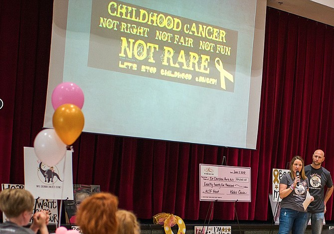 Mike and Lindsay Rhoades, founders of Kate’s Cause, Herndon-based non-profit organization created after their young daughter, Kate died of acute lymphoblastic leukemia, present a $25,000 check partnering with the Alex’s Lemonade Stand Foundation in co-funding a grant to Dr. Christian Hurtz, Ph.D. from the University of Pennsylvania seeking less toxic treatments for the childhood cancer. 