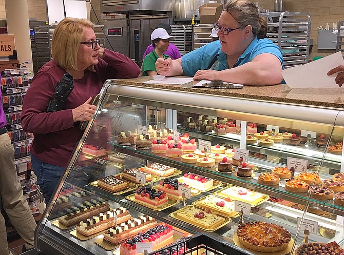 Little Rocky Run’s Deborah Aceto-Milton (left) orders a birthday cake from baker Amy Harper.