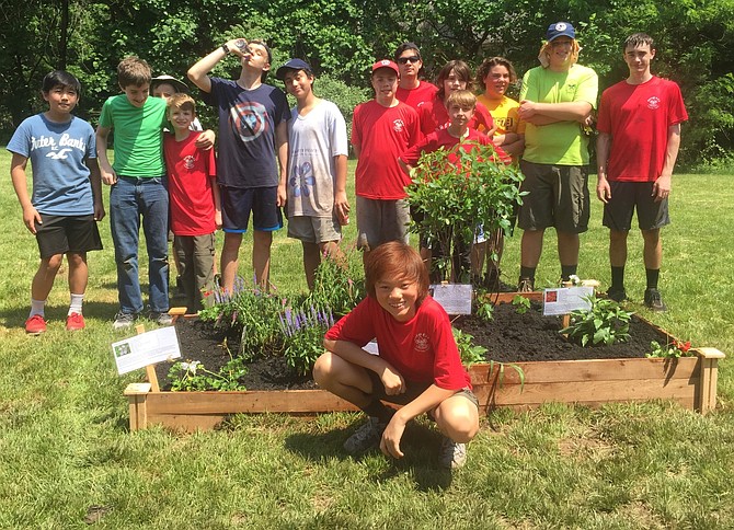 Thirty scout and parent volunteers helped install a learning and butterfly garden for Forestville Elementary School.