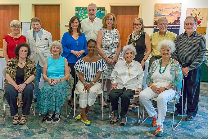 Great Falls Write’rs Group authors gather before the event. Standing, from left: Nancy Hannan, Clarence Ashley, Jennifer Hammond, Adriaan Verheul, Mary McKay, Darlene Dietrich, Bill Lewers, J. Robert DiFulgo. Seated: Jody Politzer, Catherine Mathews, Kristin Clark Taylor (founder GFWG), Mary Dacoba, Pu-Chin Hsueh Waide.