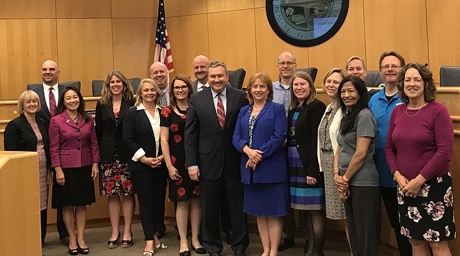"It is our privilege to serve the residents of the Town of Herndon, “ said Jeff Bentley, President/CEO of Northwest Federal Credit Union (center, front row) as he gathers with other staff members of the financial institution, town staff, and members of the Festival Executive Committee at the Herndon Town Council Public Session held May 22, 2018. 