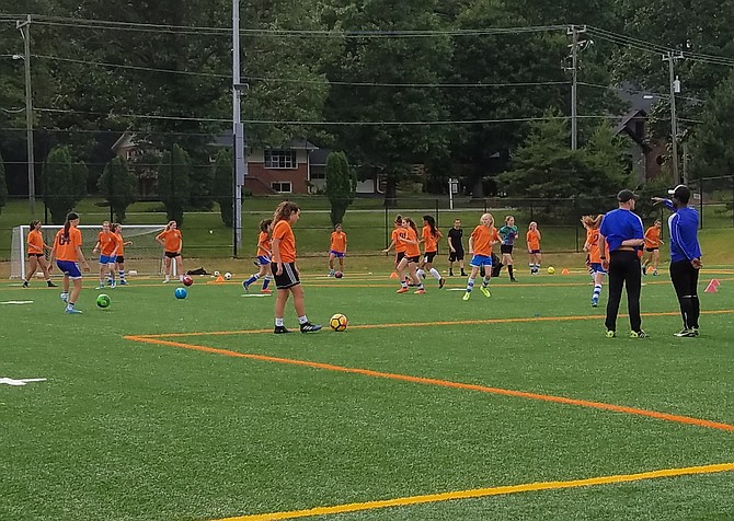 Coach Radovan Pletka, on the right, directing his team through their drills.
