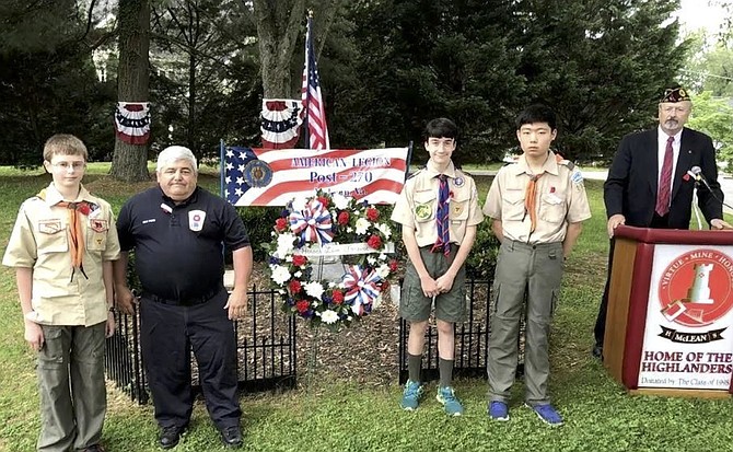 Scouts from Troops 652 and 1130 and Fairfax Fire Department personnel laid the memorial wreath at the Memorial Day ceremony sponsored by the McLean American Legion Post 270 as the Post Commander looks. The ceremony took place at the McLean High School Memorial Garden.