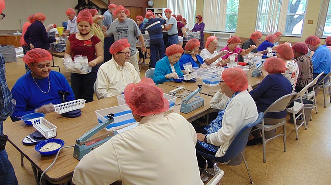 About 70 volunteers helped package boxes with rice and soy for a third-world country at Wesley United Methodist Church.