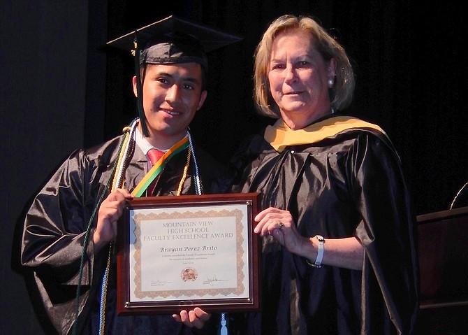 Brayan Perez Brito receives the Faculty Award from counselor Ellen Fay.