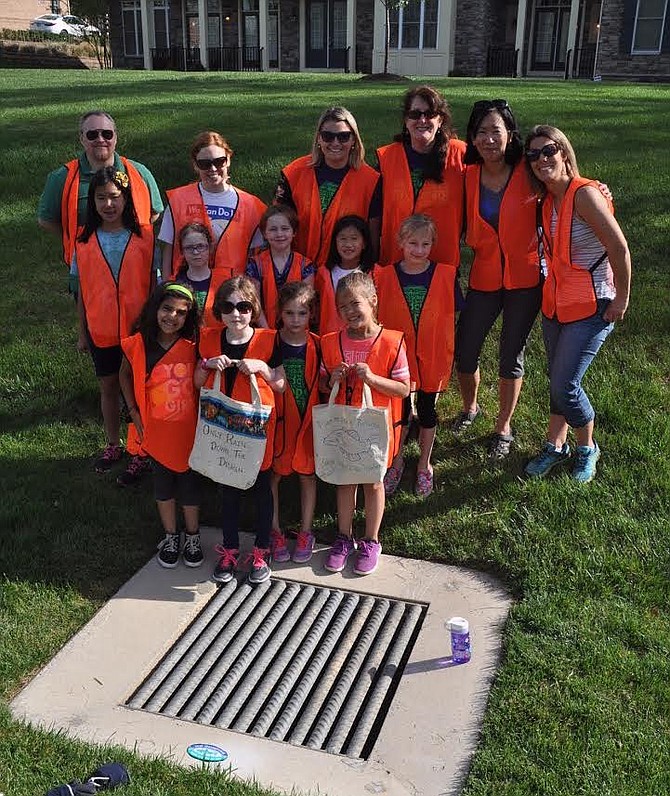 Labeling storm drains with the message "No Dumping" with Northern Virginia Soil and Water Conservation District.