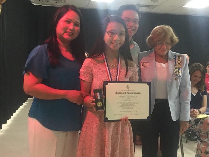 Kelsey Vu, the winner of the DAR Youth Citizenship Award at Ravensworth ES, with parents Mr. and Mrs. Vu; and Jeannie Leson, Anna Maria Fitzhugh Chapter, NSDAR.