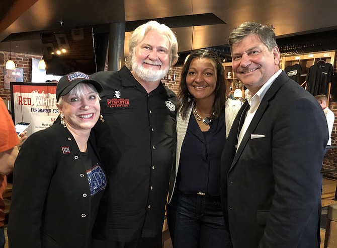 Elaine Rogers, left, president and CEO of USO Metropolitan Washington-Baltimore, joins celebrity chef Myron Mixon and Giant Food executive Felis Andrade and division president Gordon Reid June 19 at Myron Mixon’s Pitmaster BBQ Restaurant in Alexandria for the 2nd annual Red, White and BBQ fundraiser to help aid American troops.