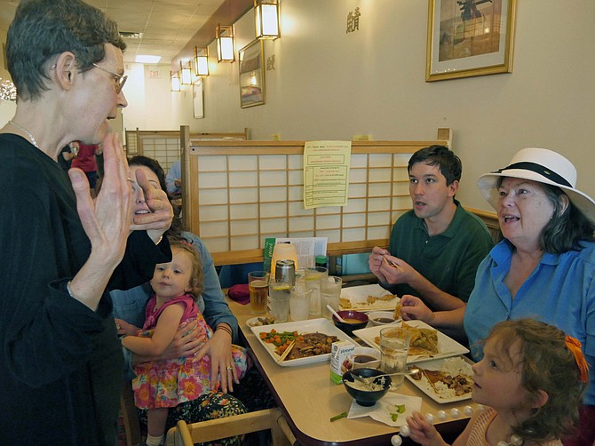 Rosie Gordon-Mochizuki chats with three generations of the Almand family who have gathered at Sushi Zen on June 20 to celebrate the 20th fundraiser of the year. This fundraiser is for Arlington Neighborhood Village (ANV). Elizabeth Haire Almand explains that she and her son Peter Reijmers came from Charlottesville to visit her daughter and two grandchildren, Arden and Emily, in Arlington. She says when she asked her son to choose where to eat, "the answer was immediately Sushi Zen."
