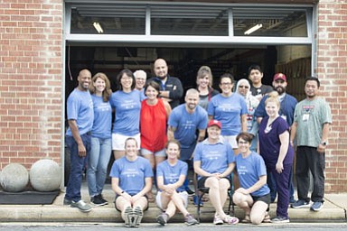 Trish Gibson (middle with the red cap) surrounded by her CrossFit community.